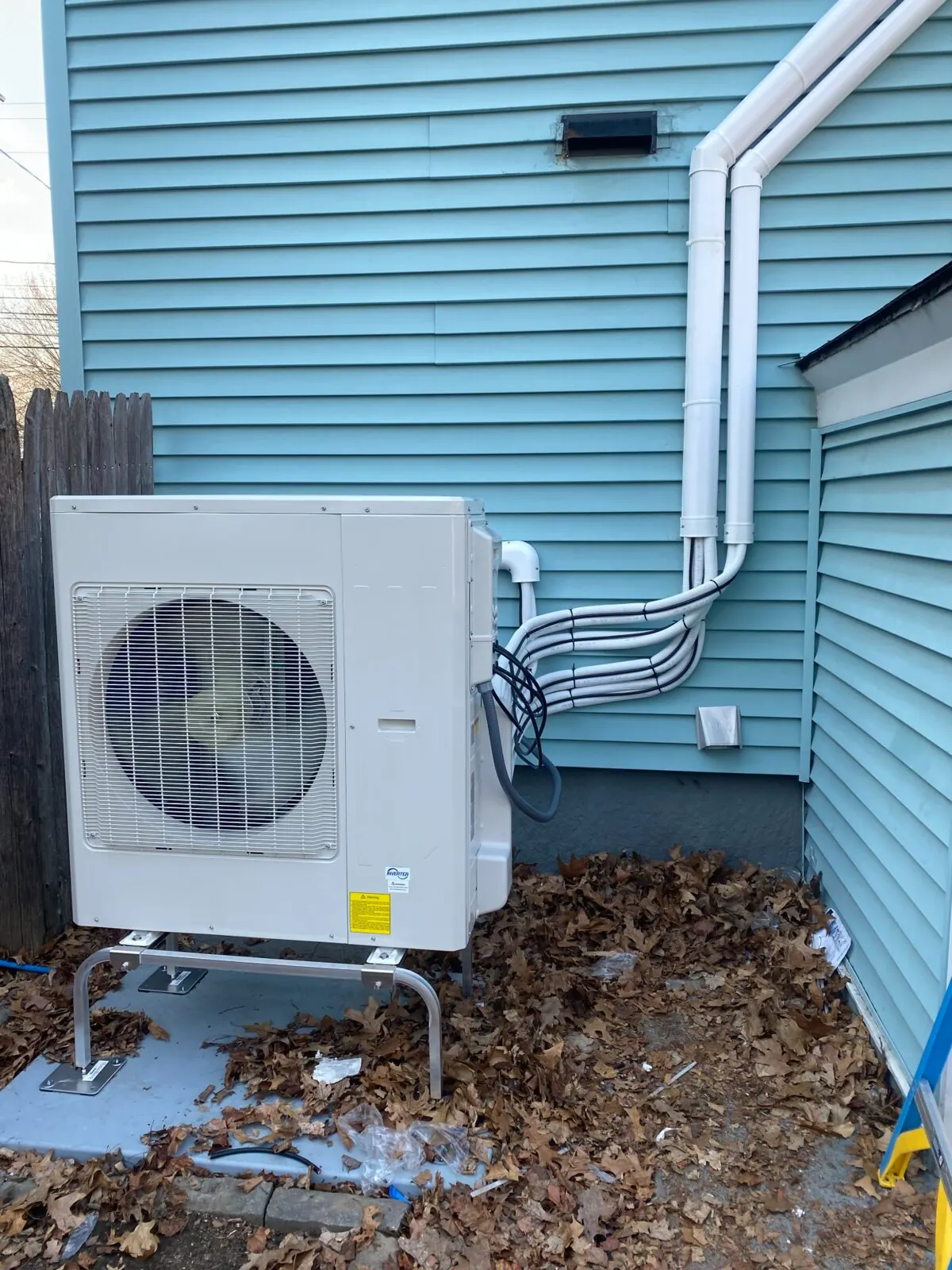 Outdoor mini-split unit and refrigerant line routing