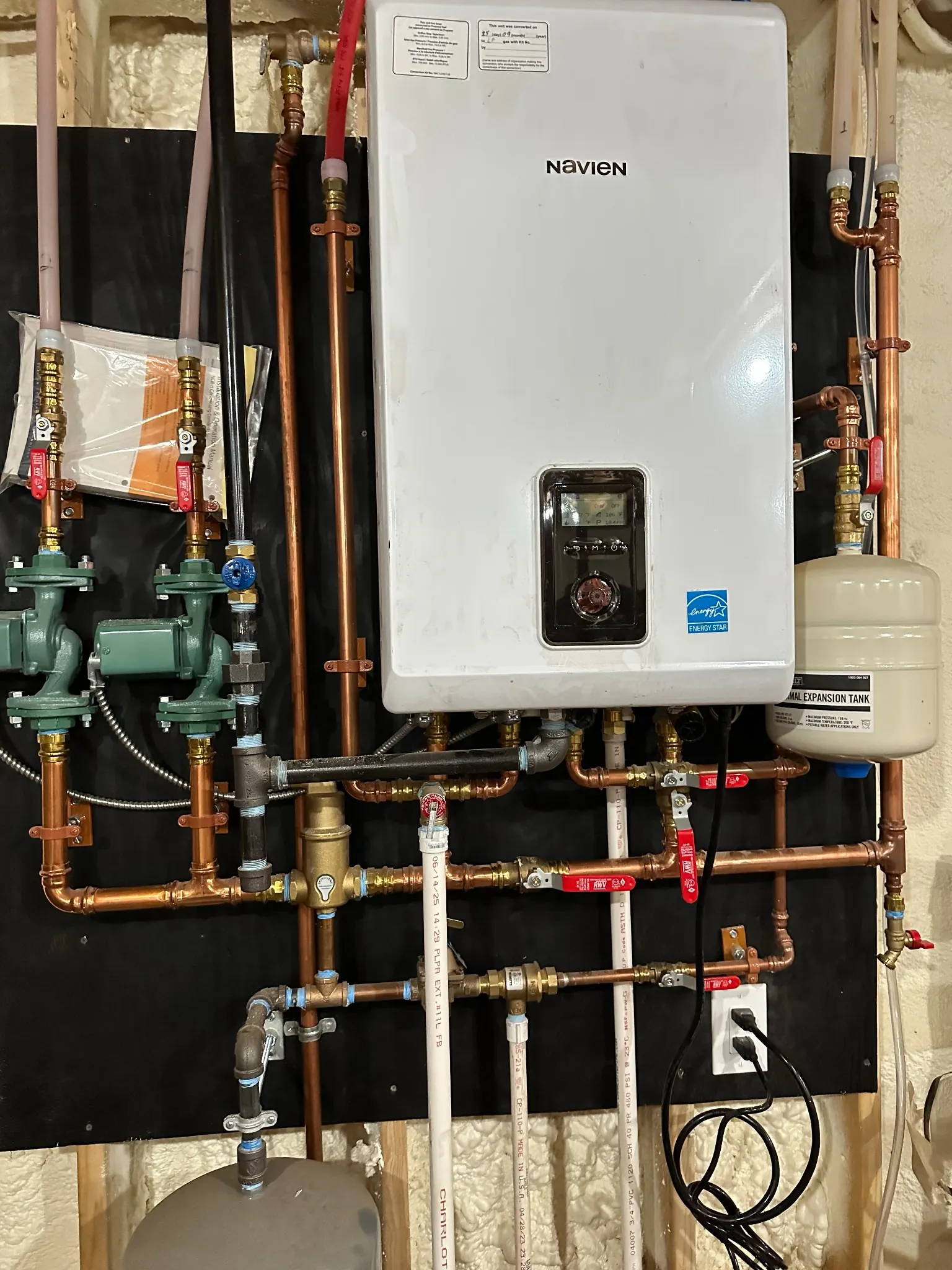 Detail of a Navien system with copper piping and circulators